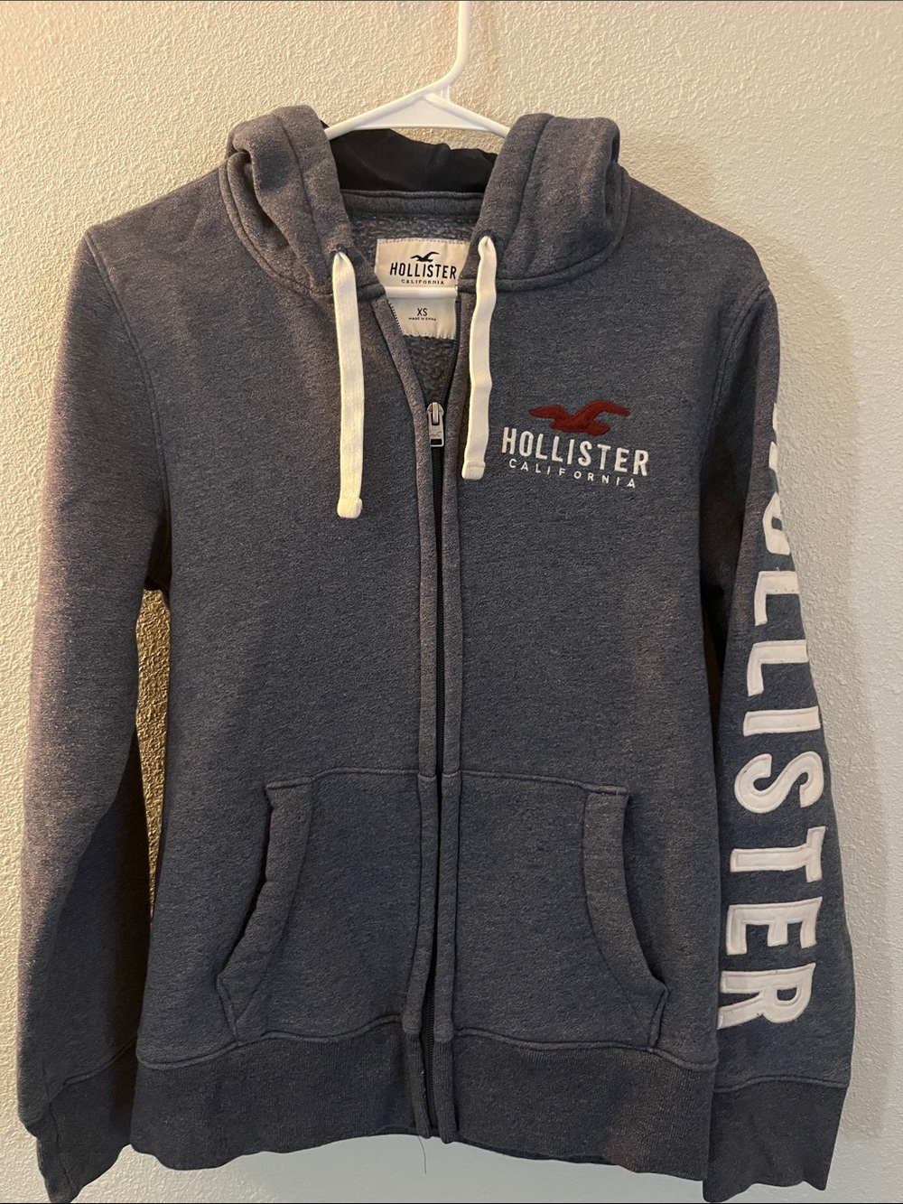 Hollister Men's Navy Zip Front Hoodie with White Drawstrings